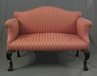 A Chippendale period mahogany framed 2 seat settee, upholstered pink striped material, raised on carved cabriole ball and claw supports 52"