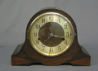 A 1930's 8 day chiming mantel clock contained in an oak Admiral's hat shaped case