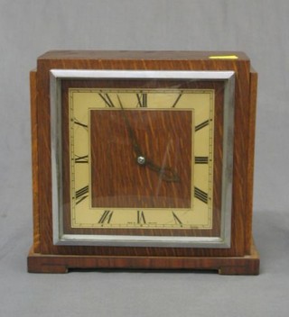 A 1930's 8 day striking mantel clock with square dial, Roman numerals contained in an oak case