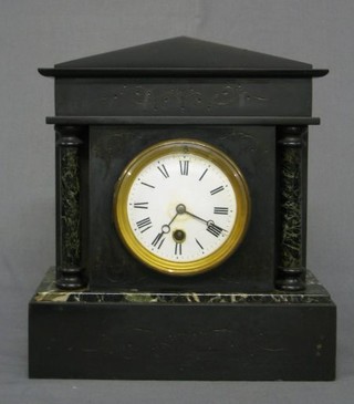 A Victorian French 8 day mantel clock with porcelain dial and Roman numerals contained in a black marble architectural case, flanked by a pair of columns