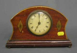 A bedroom timepiece contained in an arched inlaid mahogany case