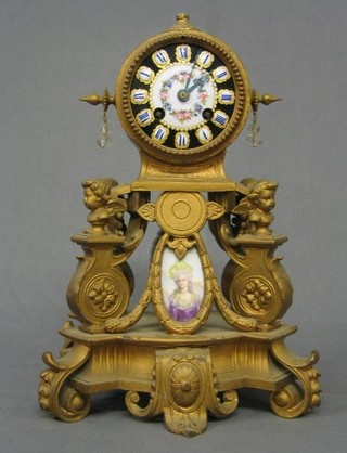 A 19th Century French 8 day striking clock with porcelain dial contained in a gilt spelter case surmounted by a lidded urn (f)