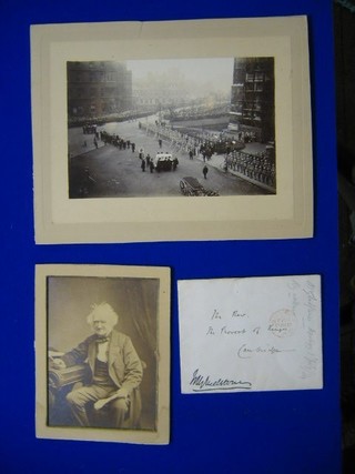 A small House of Common's envelope marked The Rev Provist of Kings Cambridge, signed Gladstone together with a 19th Century portrait photograph of a seated elderly Gladstone 6" x 4" and a black and white photograph of Gladstone's state funeral at Westminster 5" x 7"
