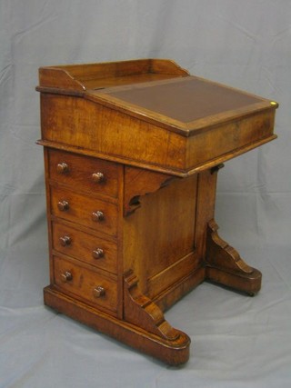 A late Victorian oak Davenport with inset tooled leather writing surface and three-quarter gallery, the pedestal fitted inkwell drawer and 4 drawers with turned handles 24"