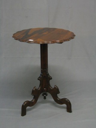A 19th Century mahogany shaped snap top wine table with pie crust edge, raised on reeded column and tripod supports 21"