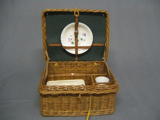 A wicker picnic basket and contents