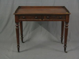 A Victorian mahogany side table with three-quarter gallery, fitted 2 frieze drawers, raised on turned supports ending in brass caps and castors 36"