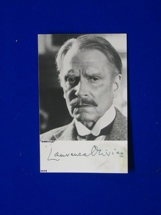 A black and white postcard of Lawrence Olivier with full Lawrence Olivier signature