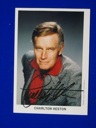 A signed colour photograph of Charlton Heston