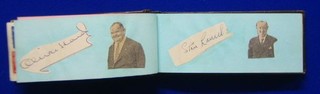 A small leather autograph album containing Stan Laurel and Oliver Hardy's signatures on scraps of paper, also containing stamps and other minor signatures