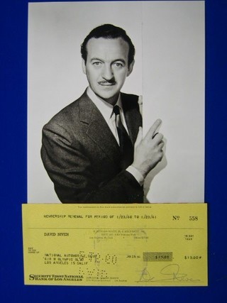 A signed cheque for membership renewal for the National Automobile Club for $15.00 signed by David Niven, together with a black and white photograph