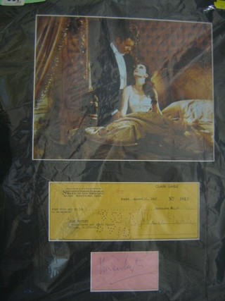 A colour photograph "Gone with The Wind" mounted with a 1946 cheque signed by Clark Gable and a separate piece of paper signed by Vivien Leigh