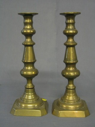 A pair of brass candlesticks with ejectors 12"