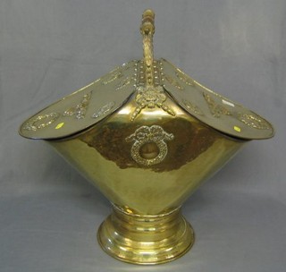 A Victorian polished brass double coal bin with cast decoration