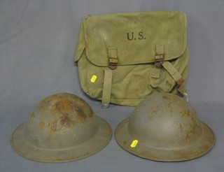 2 WWII steel helmets and an American cloth satchel marked US