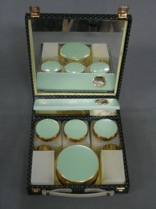 A 1950's lady's vanity case fitted 6 plastic bottles