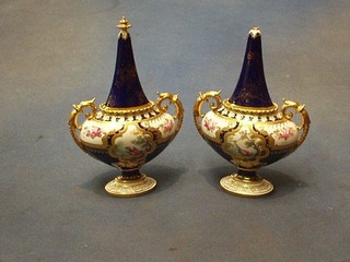 A pair of Royal Crown Derby porcelain twin handled urns and covers with blue and gilt banding 8" (1 f and r)