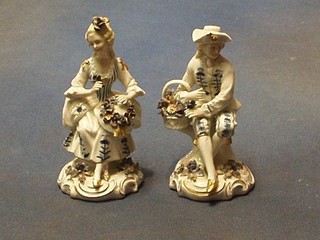A pair of 20th Century German porcelain figures of a seated lady and gentleman 4"