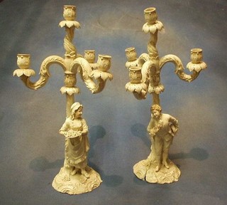 A pair of large and impressive Continental porcelain 5 light candelabrums supported by a figure of a lady and gentleman, 20" (1 heavily f and r)
