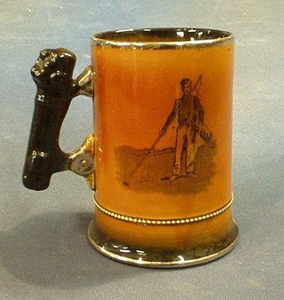 An Arthur Wood Royal Bradwell pottery tankard decorated a golfer 5"