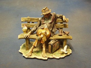 A Capo Di Monte style figure of a seated tramp 10"