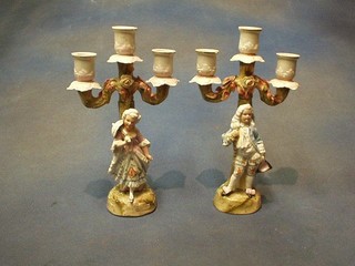 A pair of 19th/20th Century German porcelain twin light candelabrum supported by a lady and gentleman 10"