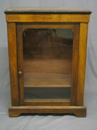 A Victorian inlaid walnutwood pier cabinet, the interior fitted adjustable shelves enclosed by glazed panelled door, the base raised on bracket feet 28"