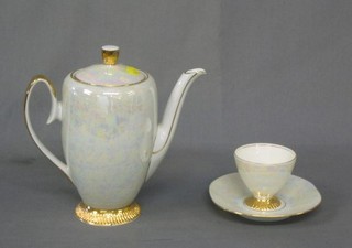 A 26 piece Continental porcelain tea service of shaped outline with floral decoration comprising 2 bread plates, 8 tea plates, sugar bowl and saucer, 7 cups and 8 saucers, together with a 14 piece lustre Continental coffee service comprising coffee pot, sugar bowl and cream jug, 5 cups and 6 saucers, and 2 small pottery jardinieres and 2 German porcelain plates 4"