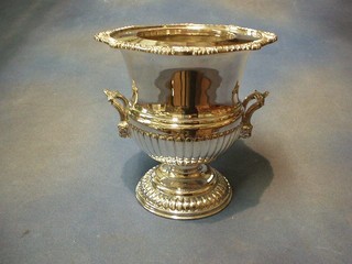 A silver plated wine cooler of campanular form with cast rim, the body with demi-reeded decoration, raised on a circular spreading foot, 9"