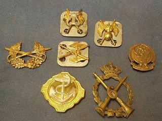3 foreign military cap badges, a naval belt buckle and 3 signallers metal badges