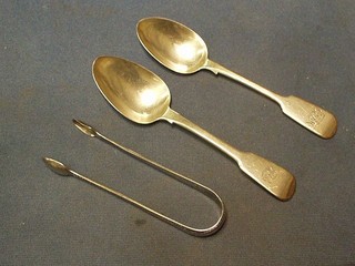 A pair of Georgian bright cut silver sugar tongs and a pair of Victorian Old English pattern silver table spoons