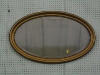 An  oval bevelled plate wall mirror contained in a gilt frame 31"
