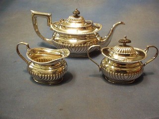 A silver plated 3 piece tea service with teapot, cream jug and twin handled sugar bowl and cover, with demi-reeded decoration