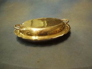 An oval silver plated entree dish and cover