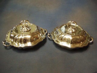 A handsome pair of circular shaped silver plated twin handled entree dishes and covers, the interior with dividers, by Mappin & Webb