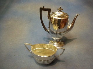A silver plated coffee pot with demi-reeded decoration and matching twin handled cream jug, by Walker & Hall