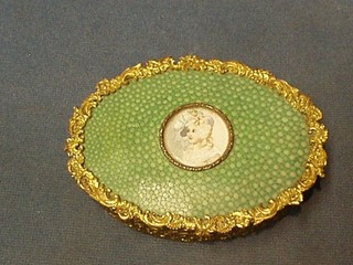 A 19th/20th Century oval gilt metal trinket box, the lid decorated shagreen and having a porcelain panel to the centre 4"