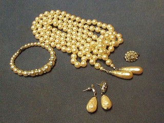 A string of simulated pearl beads with matching bracelet and earrings