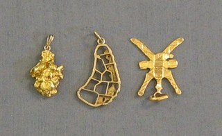 A gold pendant in the form of the island of Barbados, a gold pendant in the form of 2 crossed knives together with a gold nugget pendant