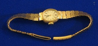 A lady's Rotary wristwatch contained in a 9ct gold case and with integral bracelet