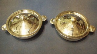 A pair of circular silver plated twin handled dishes and covers 6"