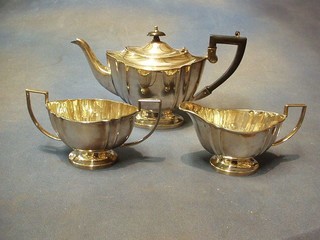 An oval 3 piece silver plated tea service with teapot, twin handled sugar basin and cream jug