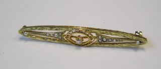 A high carat gold pierced boat shaped brooch set a rose cut diamond and 12 demi-pearls