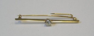 A lady's gold bar brooch set an old rose cut diamond