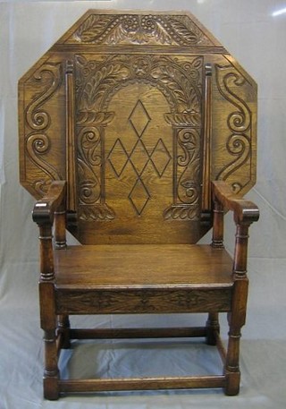 A Victorian octagonal monks bench, heavily carved throughout, the seat fitted 2 drawers, raised on turned and block supports