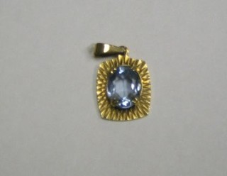 A 9ct gold pendant set a blue stone