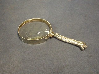 A magnifying glass with silver handle in the form of a leopards head