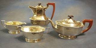 A silver 4 piece tea service of oval panelled form comprising tea pot, twin handled sugar basin, cream jug and hotwater jug, Birmingham 1949 44 ozs