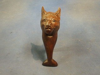 A pair of carved Swiss nut crackers in the form of a wolf's head