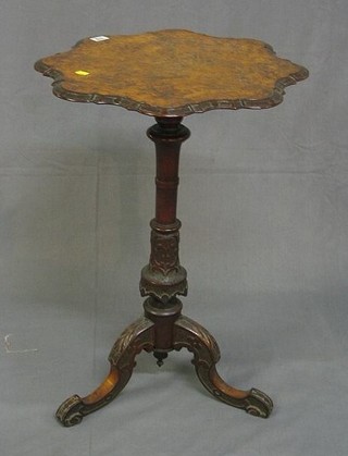 A Victorian circular figured walnutwood wine table raised on a carved column and tripod support 19"